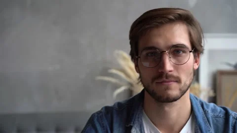 Smiling bearded millennial man looking at camera. Close up face view portrait Stock Footage 142875944