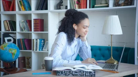 Smiling beatiful female student using video confirence with her teacher and Stock Footage 104408225