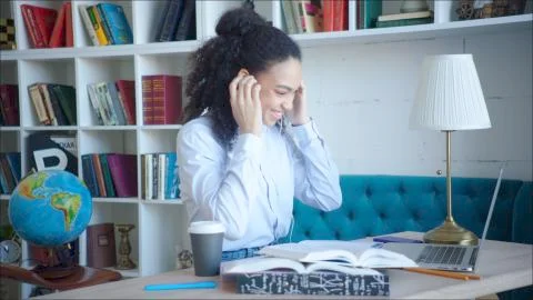 Smiling beatiful female student using video confirence with her teacher and Stock Photos