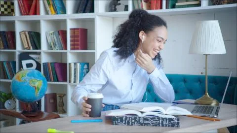 Smiling beatiful female student using video confirence with her parents in Stock Photos