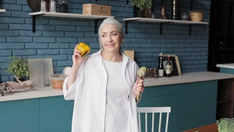 Smiling beautiful elderly gray-haired woman in a good mood dancing in the Stock-Footage 213276204