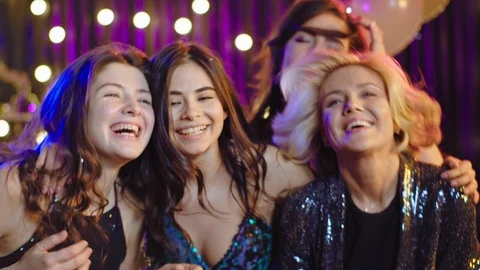 Smiling beautiful ladies posing in front of the camera at stuff party they Video stock 124166656