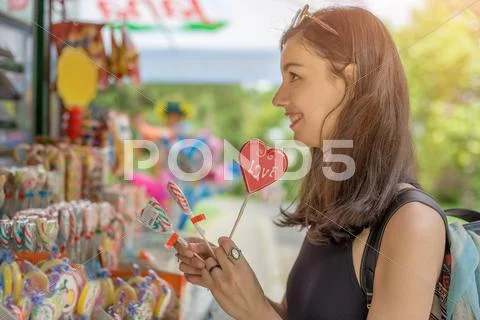 Smiling Beautiful Young Woman With Lollipops