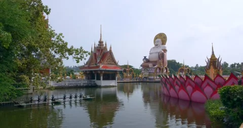 Smiling Big Buddha Stands on a Colorful Temple in Thailand. Daylight, 4K Stock Footage