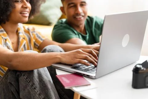 Smiling black couple using laptop at home Stock Photos
