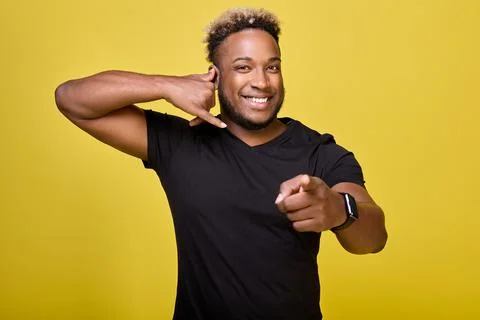 Smiling black guy points to camera, calls to call candidate and join the team Stock Photos