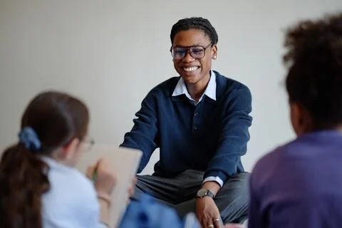 Smiling Black Man Teaching Diverse Children in Art Gallery Stock Photos