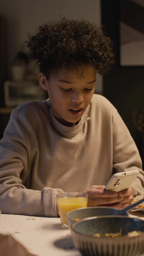 Smiling Black Teenage Boy Using Smartphone Watching Funny Videos Vertical Stock Footage 335327741