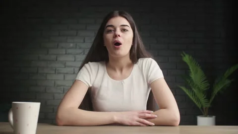 Smiling blogger waving hello while recording her vlog. A positive brunette Stock Footage 232804688