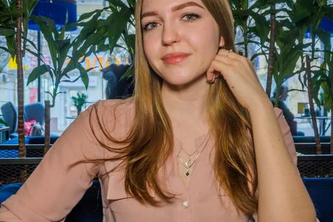 Smiling blonde is resting in cafe. Stock Photos