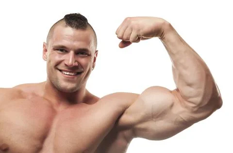 Smiling bodybuilder flexing arm. White background, studio shot. Stock Photos
