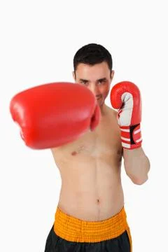 Smiling boxer attacking with his right fist Stock Photos
