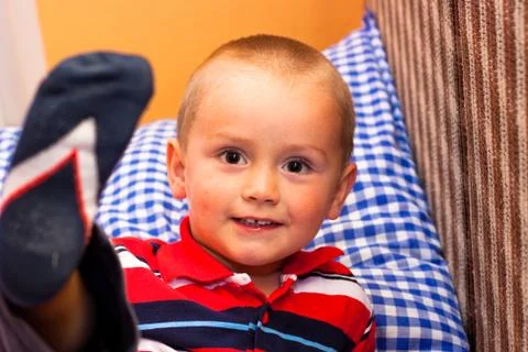 Smiling boy on the bed Stock Photos