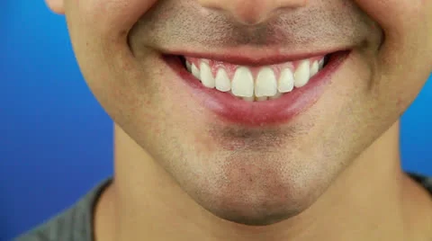 A smiling boy at the blue background Stock Footage 22759691