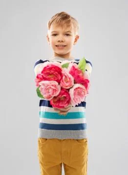 Smiling boy with bunch of peony flowers Stock Photos