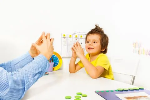 Smiling boy exercises improving motor skills Stock Photos