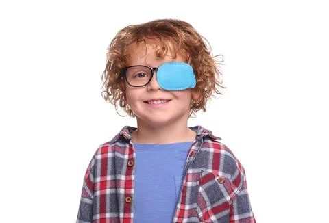 Smiling boy with eye patch on glasses against white background. Strabismus .. Fotos de archivo