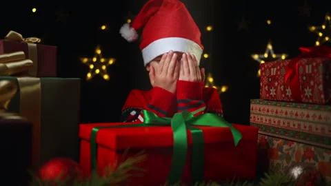 A smiling boy, filled with delight, receives gifts for Christmas. Stock Footage 286227845