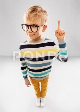 Smiling boy in glasses and striped pullover Stock Photos