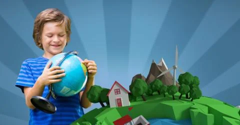 Smiling boy holding globe while standing against 3d image of planet earth 스톡 사진