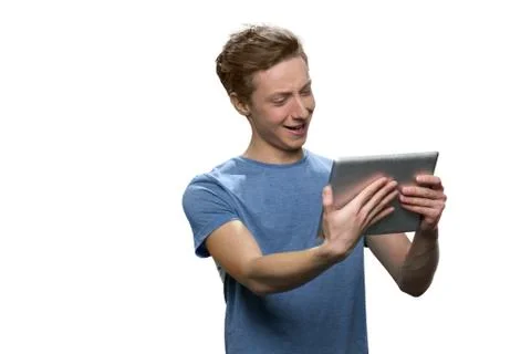 Smiling boy is holding tablet pc. Stock Photos