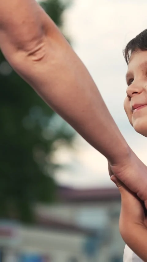Smiling boy kid son walking with mother at summer park holding hands enjoy happy Stock Footage 266972974