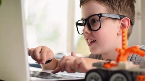 Smiling boy learning coding and programming. Robotics, STEM Education. Stock Footage 196792867