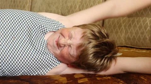 Smiling boy lies on a sofa Stock Footage 204160811