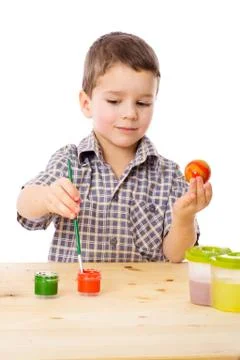 Smiling boy painting easter eggs 写真素材