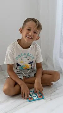 Smiling Boy Playing With Educational Alphabet And Number Game Stock Photos