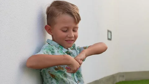 Smiling Boy Playing With a Pink Toy Outdoors Stock Footage 346326711