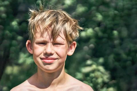 Smiling boy posing for camera in green park Stock Photos