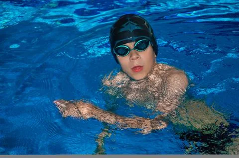 Smiling boy is practicing in the pool Stock Photos