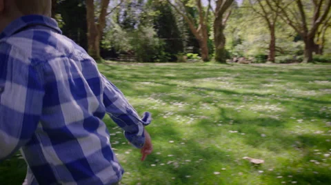 Smiling boy running in park Stock Footage 64453378