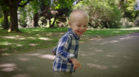 Smiling boy running in park Stock Footage 64453982