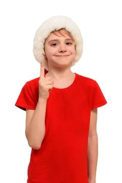 Smiling boy in Santa hat points finger up. Isolate 스톡 사진