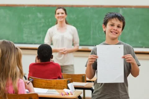 Smiling boy showing his test results Photos