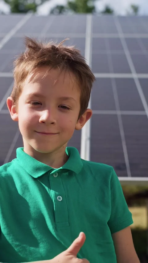 Smiling boy shows like on the background of solar panels. Stock Footage 288965553