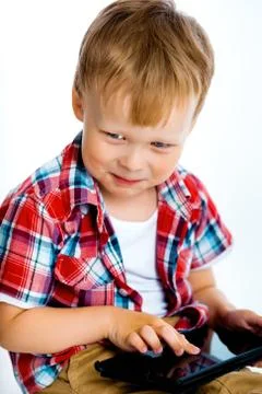 Smiling boy with a tablet computer Stock Photos