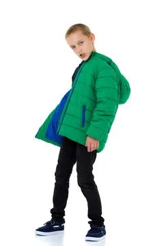 Smiling boy in unbuttoned green winter jacket Stock Photos