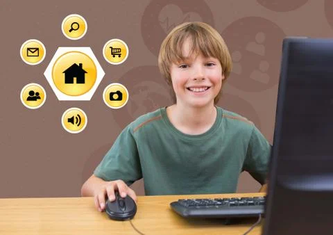 Smiling boy using desktop pc with various application icons in background Stock Photos