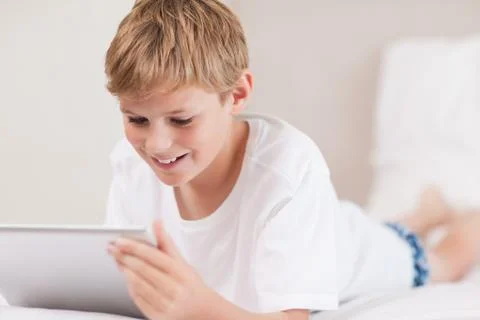 Smiling boy using a tablet computer Stock Photos