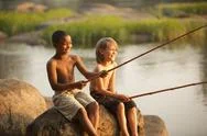Smiling Boys Fishing Together Stock Photos