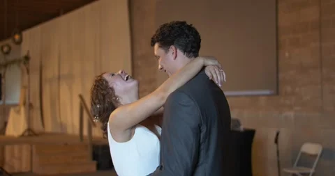 Smiling Bride and Groom Sharing a Romantic First Dance at Their Wedding Stock Footage 299691857