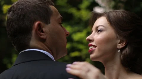 Smiling bride gently touching groom's shoulder, while they looking at each other 動画素材 64031921