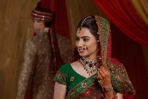 Smiling bride with husband in the background Stock Photos