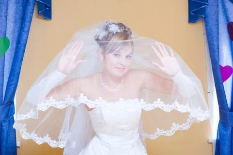 Smiling bride looking from the veil Stock-Fotos