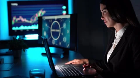 Smiling broker trading on binary option via laptop Stock Footage 269349793
