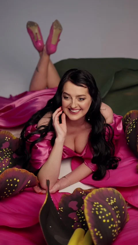 Smiling brunette with open neckline is posing on bed. Concept of sexual desire. Stock Footage 276818507