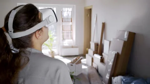 Smiling brunette in virtual reality headset looks around Video stock 135256920